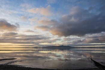 Epic sunset landscape image of Solway Firth viewed from Silloth during stunning Autumn sunset with dramatic sky and cloud formations