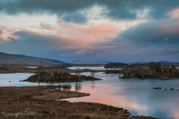 Beautiful colorful Winter sunrise landscape image across Rannoch Moor in Scottish Highlands