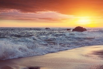 Beautiful sandy beach at sunrise for vacation background.