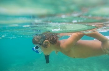 a boy underwater snorkeling in the ocean