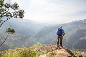 a tourist on a vantage point viewing the mountainous landscapes