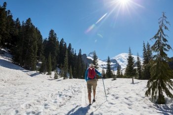 Hiker in the snow in early summer