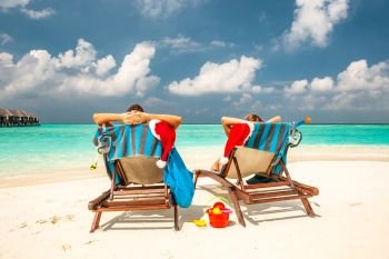 Couple on a tropical beach in Maldives at christmas