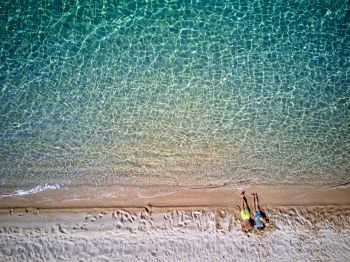 Beautiful beach with family top aerial view drone shot, Sithonia, Greece