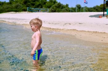 Two year old toddler boy on beach 