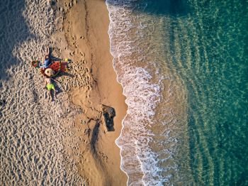 Beautiful beach with family top aerial view drone shot, Sithonia, Greece