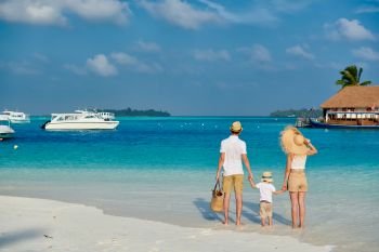 Family on beach, young couple with three year old boy. Summer vacation at Maldives.