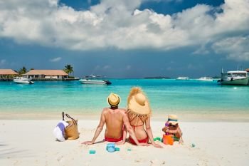 Family on beach, young couple with three year old boy. Summer vacation at Maldives.