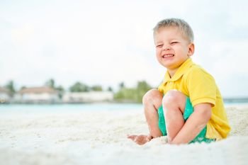 Three year old toddler boy on beach. Summer family vacation at Maldives.