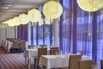 Empty dinner table in luxury hotel restaurant; 