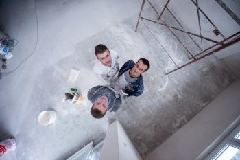 top view portrait of Workers and builders with dirty uniform in apartment that is under construction, remodeling,renovation,extension, restoration, overhaul and reconstruction