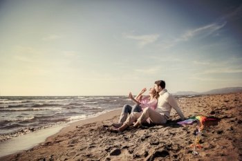 Young Couple having fun and making soap bubbles On The Beach at autumn day filter