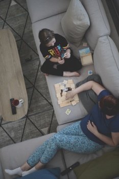 mother and daughter at home playing memory game top view