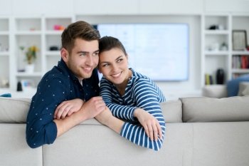 a young married couple enjoys sitting in the large living room, a young couple spending their time together
