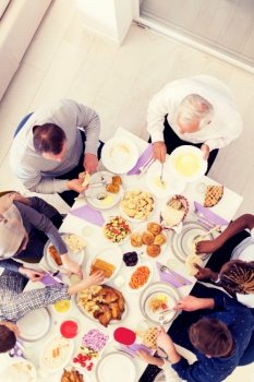 top view of modern multiethnic muslim family enjoying eating iftar dinner together during a ramadan feast at home
