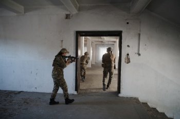 special forces soldiers team in urban environment making tactical assault action