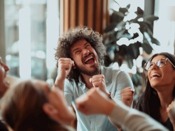 Happy diverse business people celebrating successful teamwork result, business achievement, good news, excited colleagues coworkers dancing in modern office, rejoicing victory, having fun. High quality photo. Happy diverse business people celebrating successful teamwork result, business achievement.