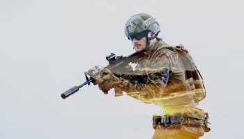 modern warfare american marines soldier in action while sneaking and aiming  on laseer sight optics  in combat position and  searching for target in battle