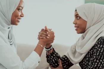 African women arm wrestling conflict concept, disagreement, and confrontation wearing traditional Islamic hijab clothes. Selective focus. High-quality photo. African woman arm wrestling conflict concept, disagreement and confrontation wearing traditional islamic hijab clothes. Selective focus 
