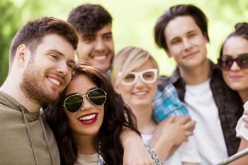 friendship, leisure and summer concept - group of happy smiling friends outdoors. group of happy smiling friends outdoors