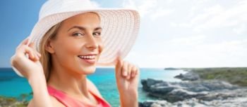 travel, summer holidays and tourism concept - portrait of beautiful smiling woman in sun hat over exotic beach background. portrait of woman in sun hat over exotic beach
