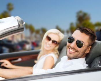 road trip, travel and people concept - happy couple driving in convertible car over venice beach background in california. happy couple driving in convertible car