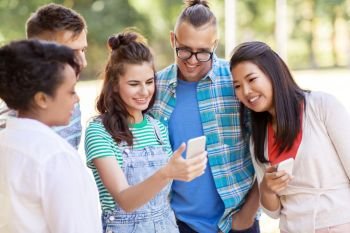 friendship, technology and international concept - group of happy smiling with smartphone outdoors. group of happy friends with smartphone outdoors