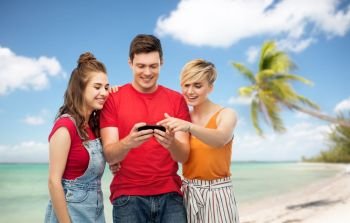 travel, tourism and summer holidays concept - group of happy smiling friends with smartphone over exotic tropical beach with palm trees background. friends with smartphone over white background