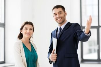 real estate business, sale and people concept - happy smiling realtor with folder showing new office room to female customer. realtor showing new office room to female customer