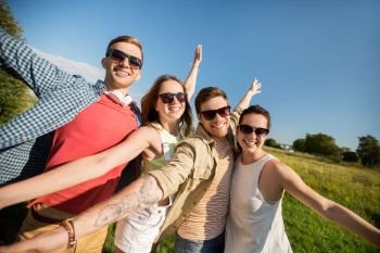 leisure, people and friendship concept - happy teenage friends having fun outdoors in summer. happy teenage friends outdoors in summer