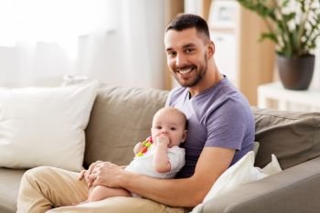 family, parenthood and people concept - happy father with little baby daughter at home. happy father with little baby daughter at home