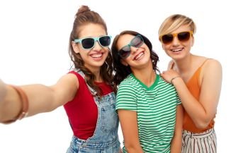 friendship and people concept - group of happy female smiling friends in sunglasses taking selfie over white background. happy female friends in sunglasses taking selfie