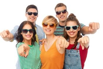 friendship, summer and people concept - group of happy smiling friends in sunglasses pointing at you over white background. friends in sunglasses pointing at you