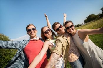 leisure, people and friendship concept - happy teenage friends having fun outdoors in summer. happy teenage friends outdoors in summer