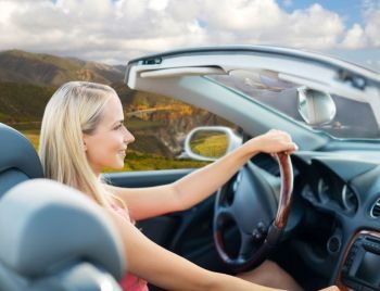 travel, road trip and people concept - happy young woman driving convertible car over bixby creek bridge on big sur coast of california background. woman driving convertible car on big sur coast