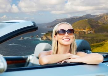 travel, road trip and people concept - happy young woman in convertible car over bixby creek bridge on big sur coast of california background. woman in convertible car on big sur coast