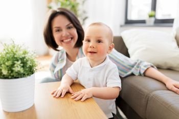 family, child and motherhood concept - happy little baby boy with mother at home. happy little baby boy with mother at home
