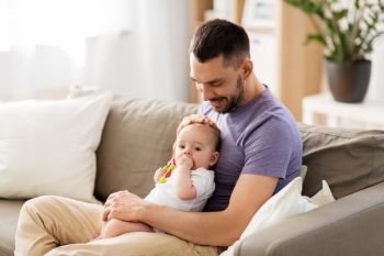 family, parenthood and people concept - happy father with little baby daughter at home. happy father with little baby daughter at home