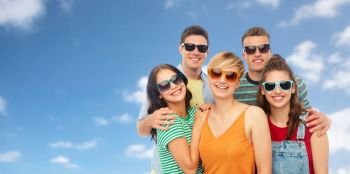 friendship, summer and people concept - group of happy smiling friends in sunglasses hugging over blue sky and clouds background. friends in sunglasses over white background