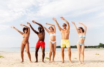 friendship, summer holidays and people concept - group of happy friends having fun on beach. happy friends having fun on summer beach