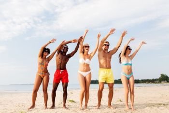 friendship, summer holidays and people concept - group of happy friends having fun on beach. happy friends having fun on summer beach