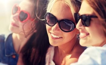 summer vacation, holidays, travel and people concept- group of smiling young women taking selfie on beach. group of smiling women taking selfie on beach