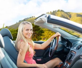 travel, road trip and people concept - happy young woman driving convertible car over big sur hills background in california. happy woman driving convertible car at big sur 