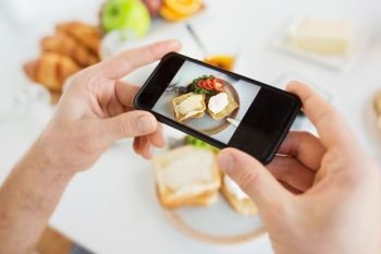 food , eating and technology concept - hands with smartphones photographing breakfast on plate. hands with smartphones photographing food