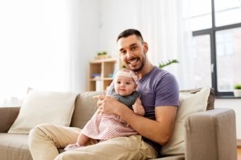 family, fatherhood and people concept - father with little baby girl at home. father with little baby girl at home