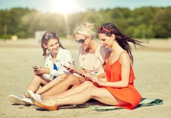 summer vacation, holidays, technology, travel and people concept - group of happy young women with smartphones on beach. group of happy women with smartphones on beach