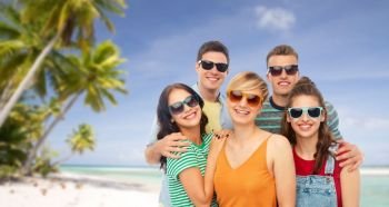 travel, tourism and summer holidays concept - group of happy smiling friends in sunglasses hugging over tropical beach background in french polynesia. friends in sunglasses over white background
