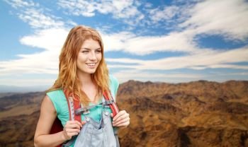adventure, travel, tourism, hike and people concept - smiling young woman with backpack over grand canyon national park hills background. smiling woman with backpack over grand canyon