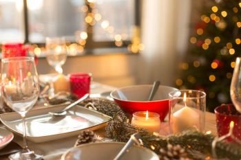 christmas, holidays and eating concept - table served for festive dinner at home. table served for christmas dinner at home