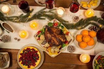christmas dinner and eating concept - roast chicken or turkey and other food on table. roast chicken or turkey on christmas table